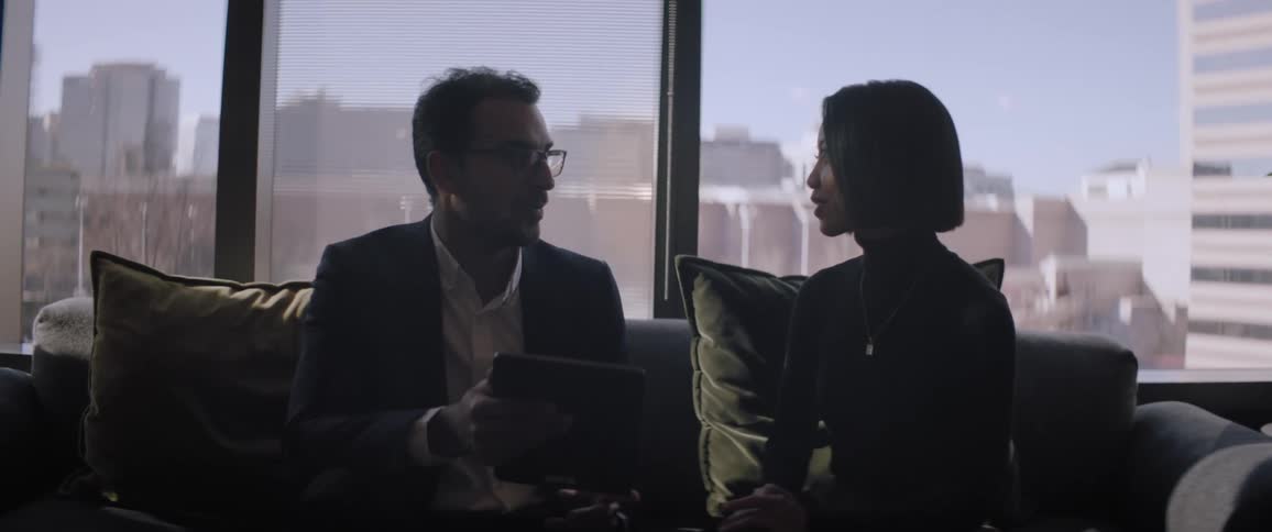 Coworkers sitting on a couch in the office
