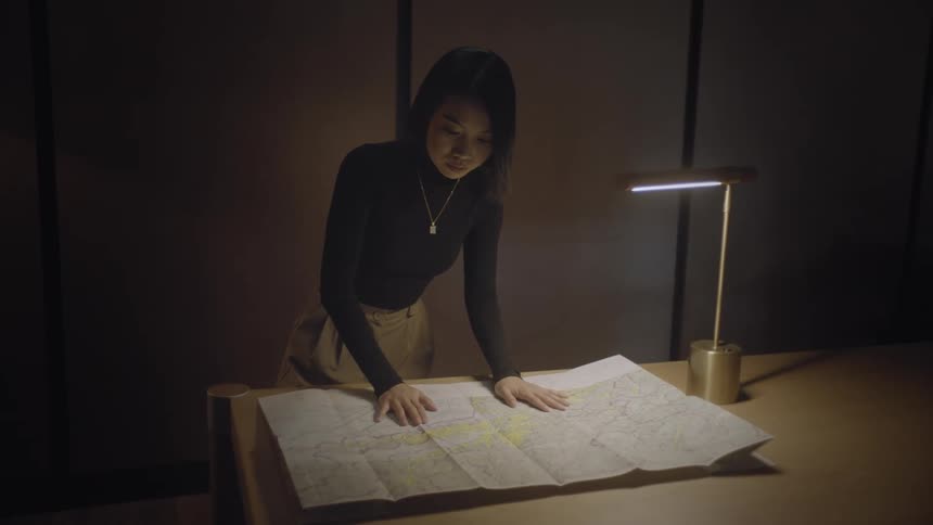 A woman is reading a map in the office
