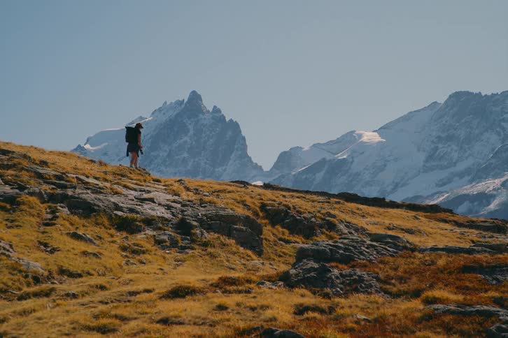 A clip of a lady hiking the mountainous area