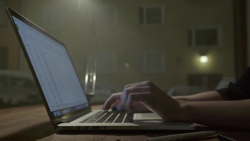 A dedicated freelancer finishes a complex digital project while working late into the night.
