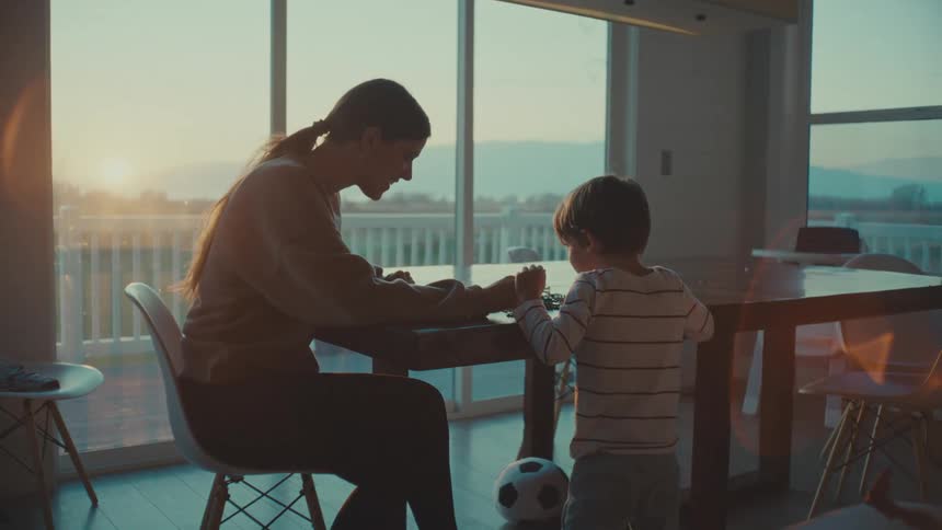 Mother playing with her son in the living room at morning