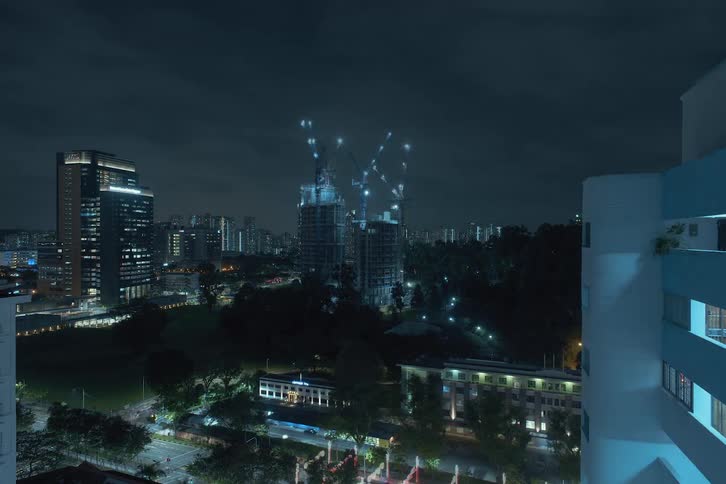 Time lapse of a pair of skyscrapers being built in the city at night