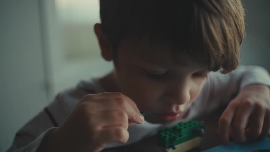 A child is building with his legos