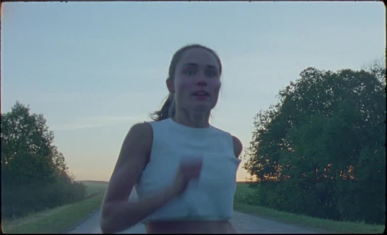 Young fit woman jogging on the countryside at morning