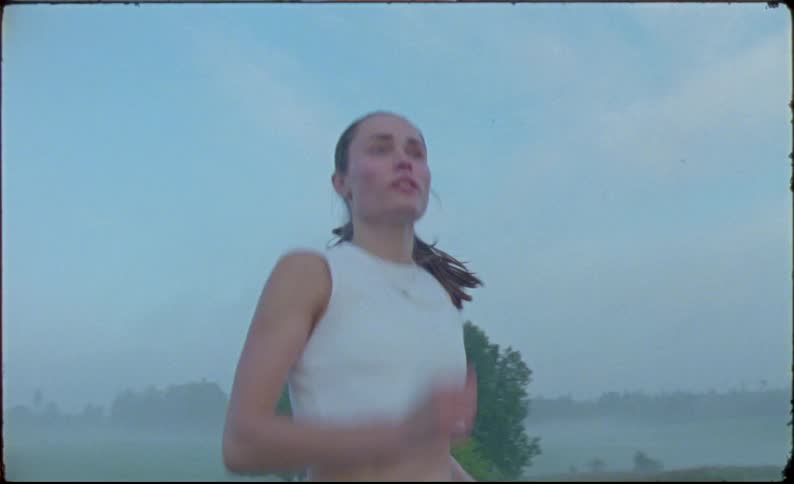Woman jogs on a treadmill in the countryside at morning