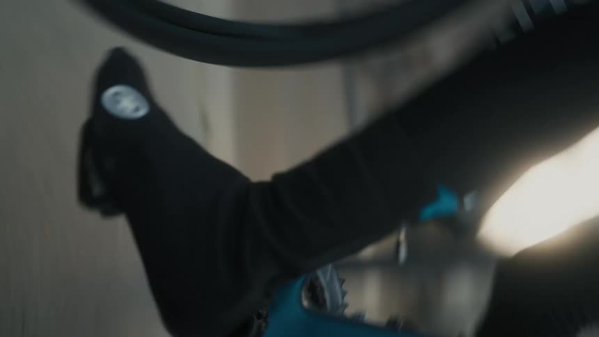 A person rides off on their bike