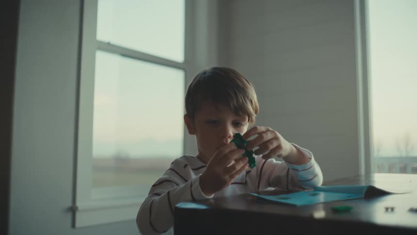 A child is playing with his legos
