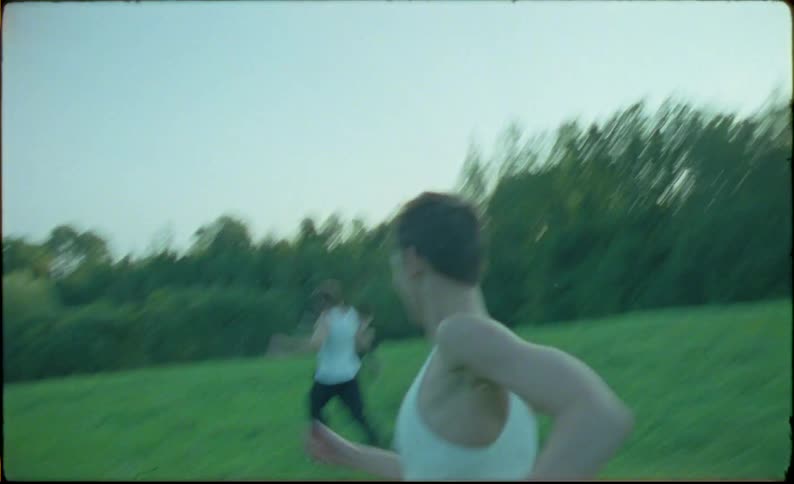 A group of teenagers race on the grass