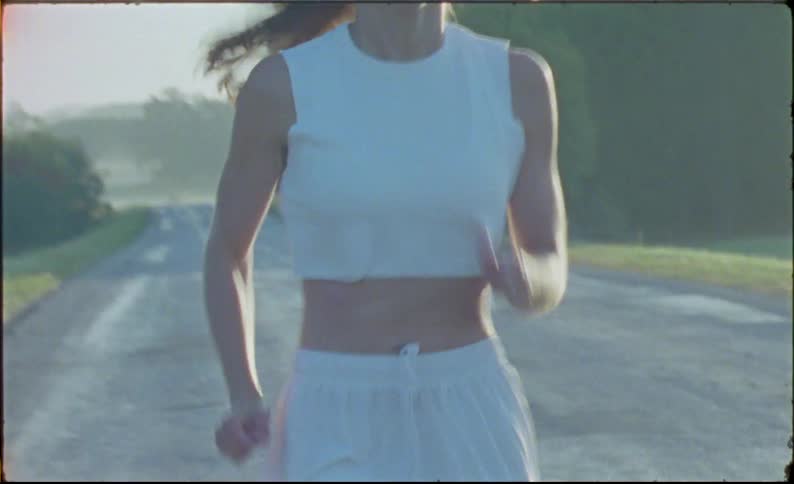 Young fit woman jogging on the countryside at morning