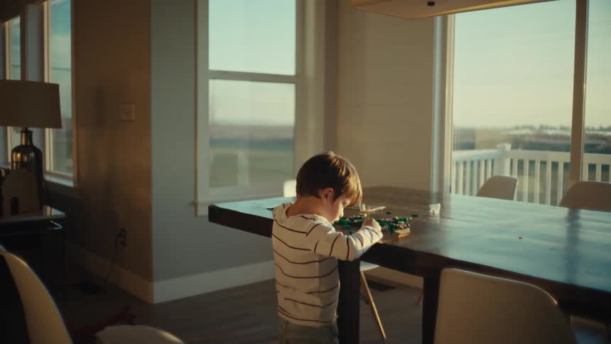 A boy is playing with his legos