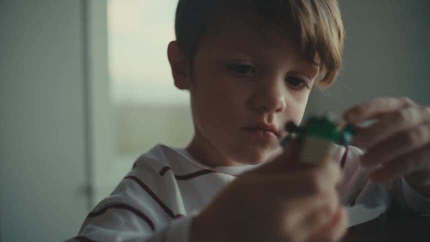 A boy is playing with legos