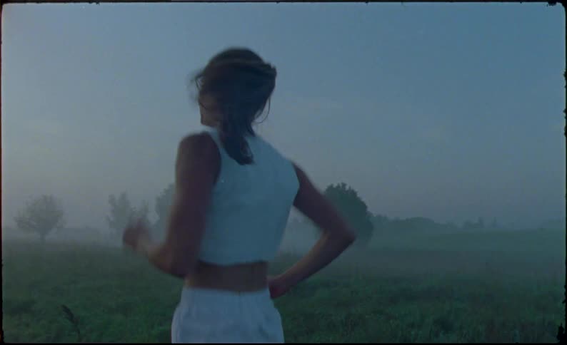A woman is running on a treadmill outside