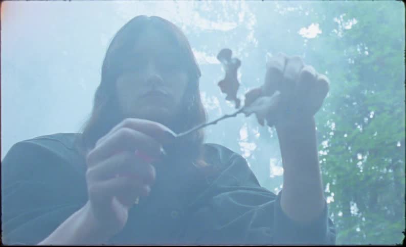 Young woman playing with a branch in the forest