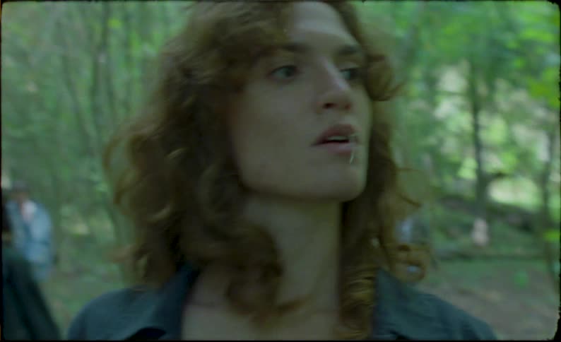 Young handsome man walking in the forest with friends