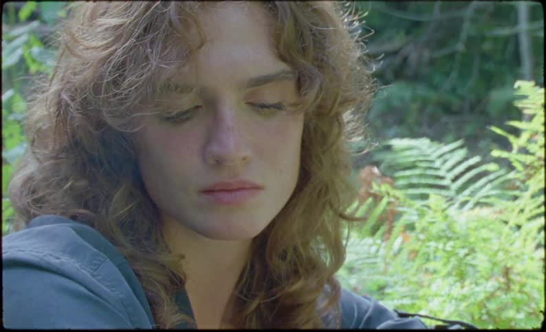 Close up of the beautiful face of a person sitting in the forest