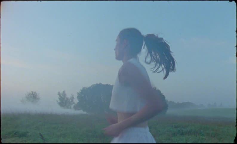 A woman is running in a rural area and is not leaving the place