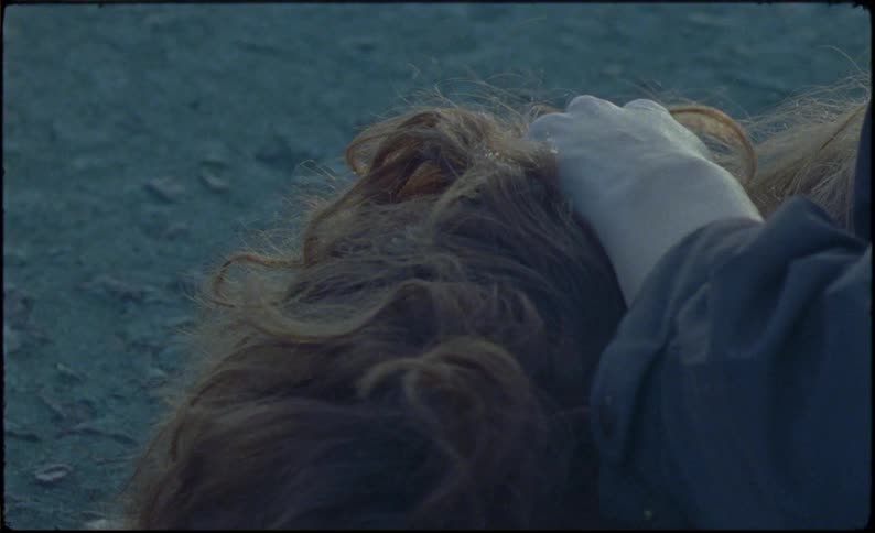 A woman is cowering on the ground