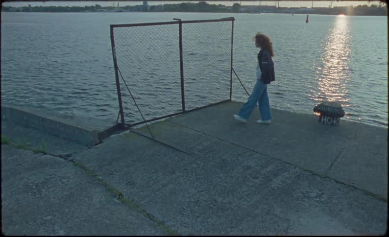 Young woman walking around a pier in the morning