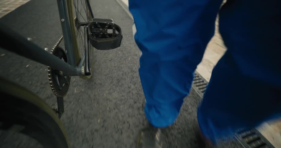Close up of a person dismounting a bicycle