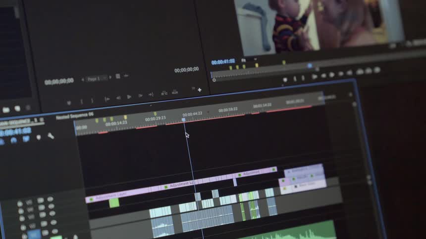 A mouse pointer is moving things on a computer screen looking through video footage
