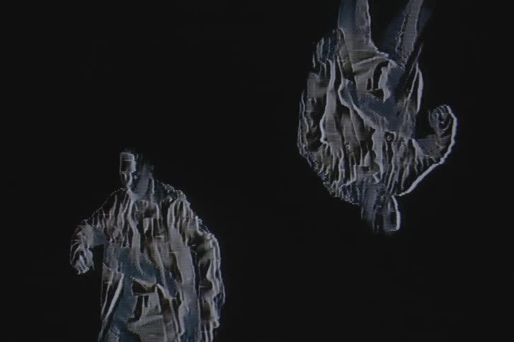 Computer effects mirror a male dancer next to an inverted copy of himself
