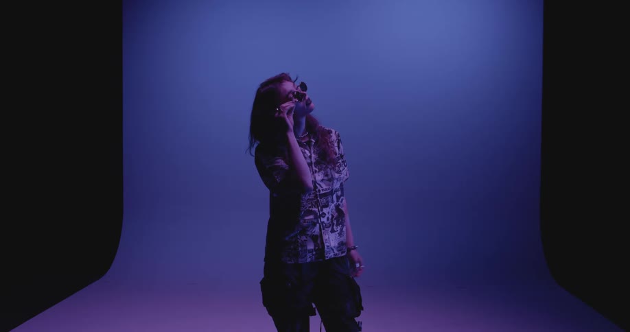 Young woman wearing sunglasses modeling in the studio