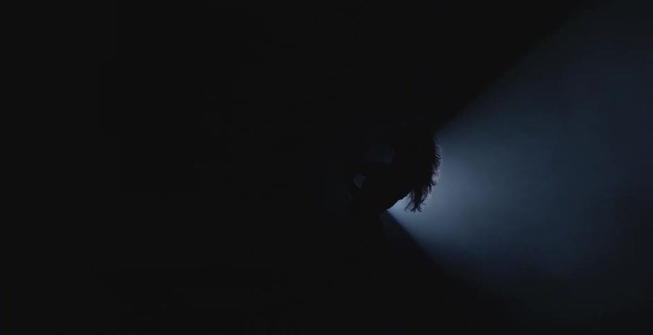 A woman is dancing in front of the spotlight