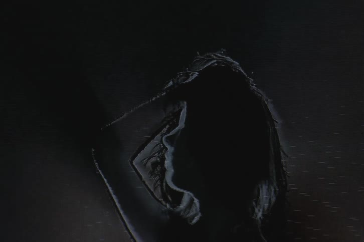 Close up of womans silhouette briefly obscured by signal static