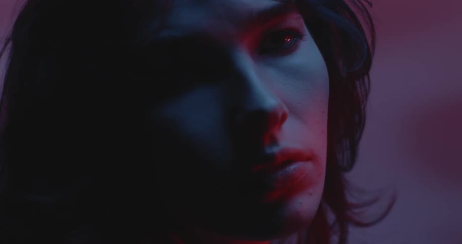 A woman is looking around in the dark