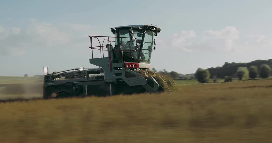 A tractor is plowing a farm field