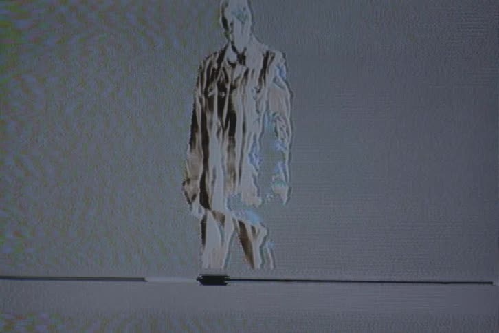 A person is standing in the static filled picture