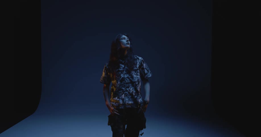 A young woman at a photo shoot in a dark studio