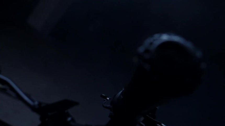 Orbiting close up of the handlebars of a black bicycle