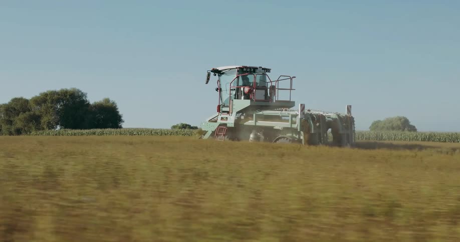 A combine harvesting crops in the fields