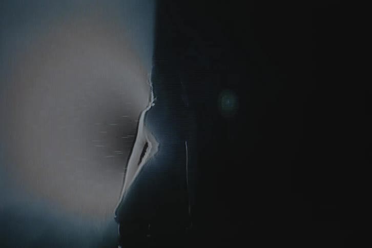 Female dancer takes different poses backlit by spotlight and cast into silhouette