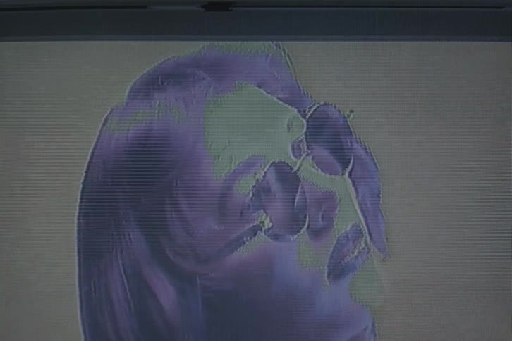 Face of a woman modeling sunglasses with vhs video distorsion