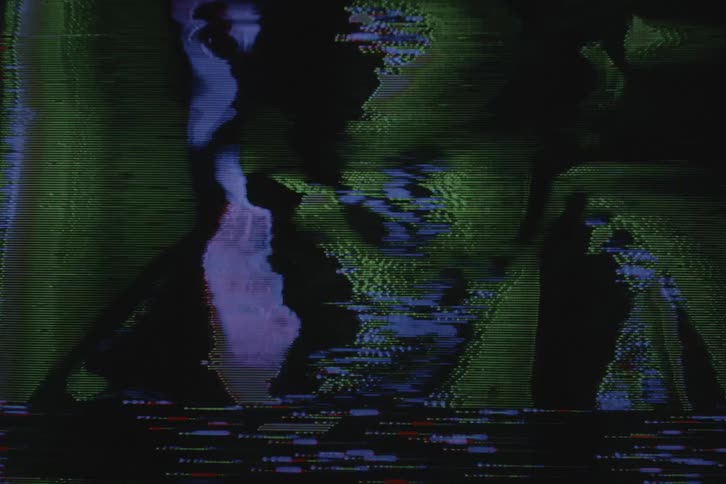 Signal static and off colors distort broadcast of mans face