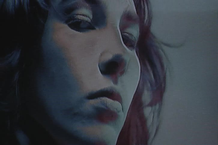 A woman touches her face
