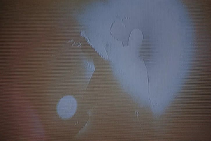 The two people are dancing in the light and shadows