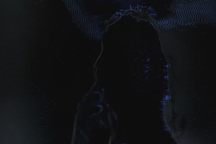 Signal noises temporarily obscures closeup of womans face