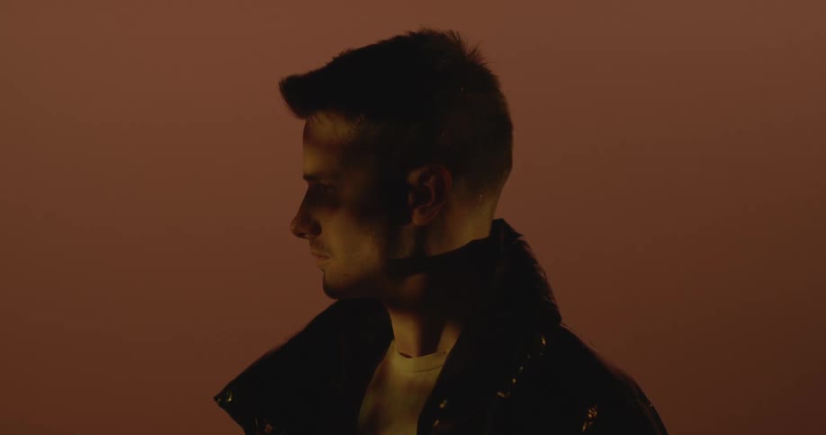 A man is looking to his side