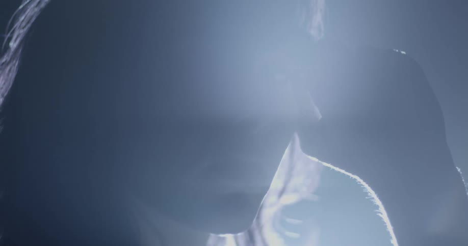 Closeup of a young womans face running her hands over her face