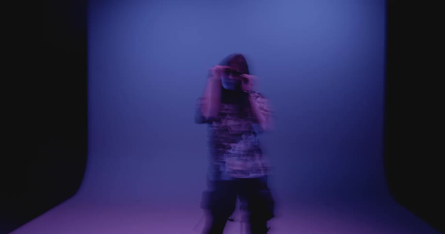 Shaky footage of a woman modeling in the studio