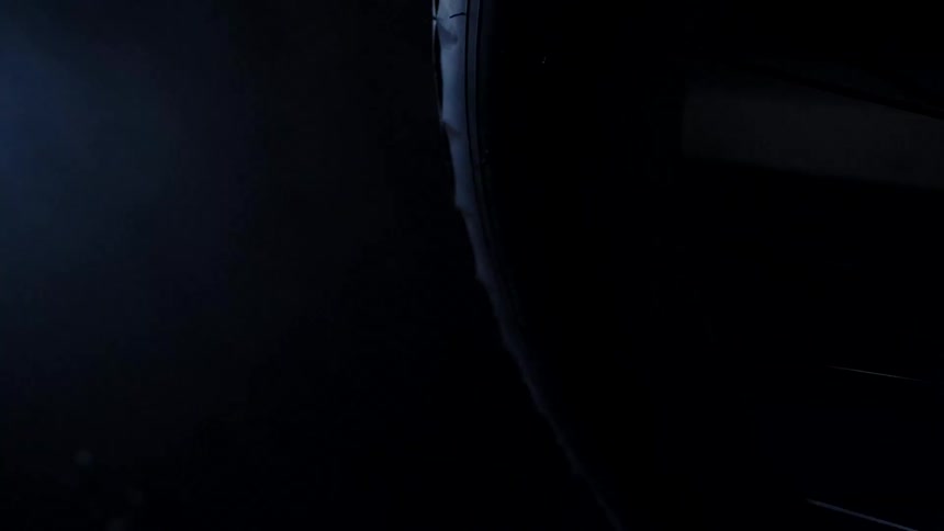 A bike is parked in the dark garage