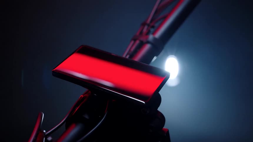 A cell phone is mounted on the handlebars