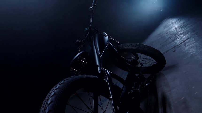 Black bicycle parked in a dimly lit room
