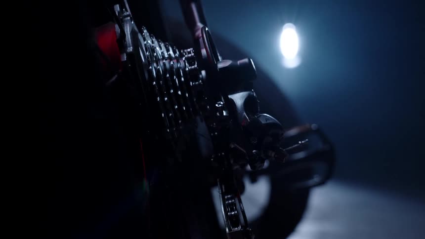 A bike is parked in the dark garage