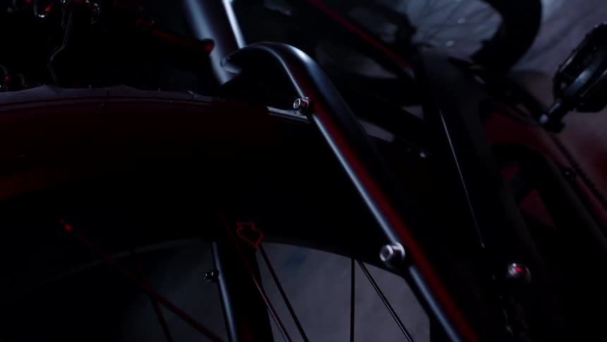 Close up of a black bicycle in a dimly lit room