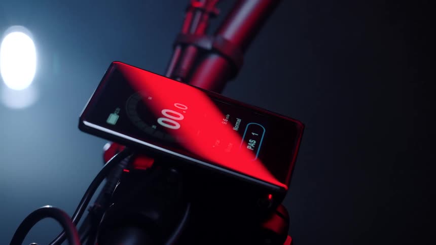 The cell phone is mounted on the handlebars