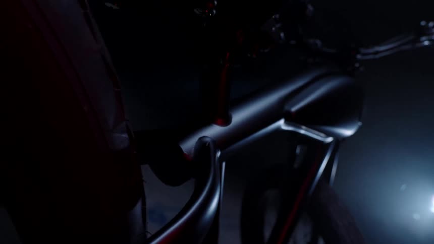 A bicycle is parked in the dark garage